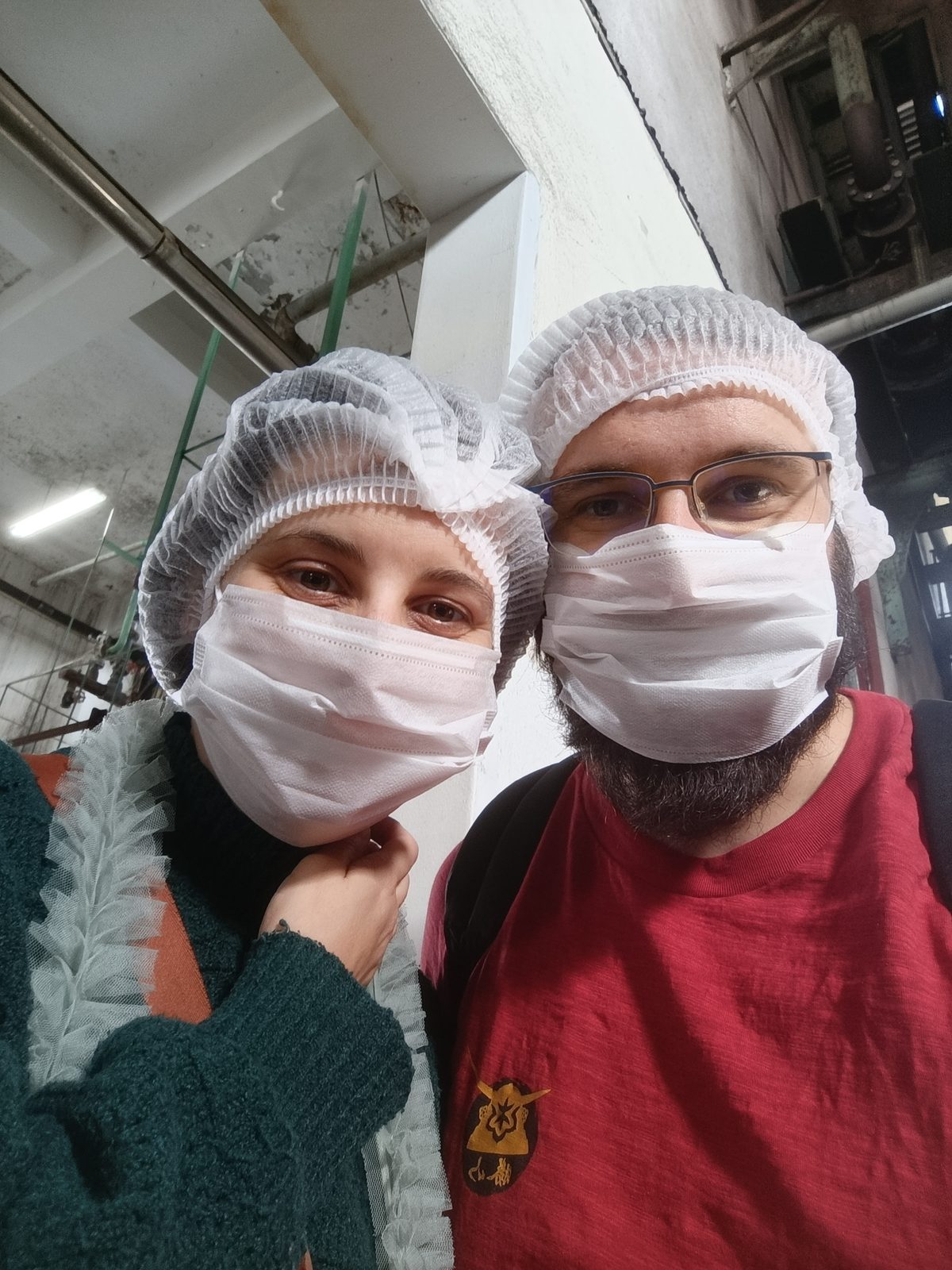 Anaïs et Alex en charlotte et masque à l'intérieur de la fabrique